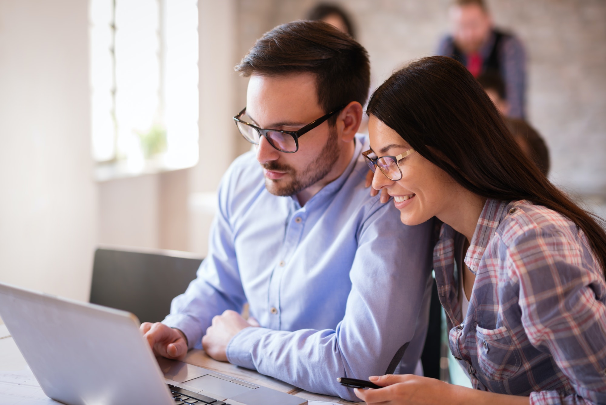 Programmers cooperating at information technology company